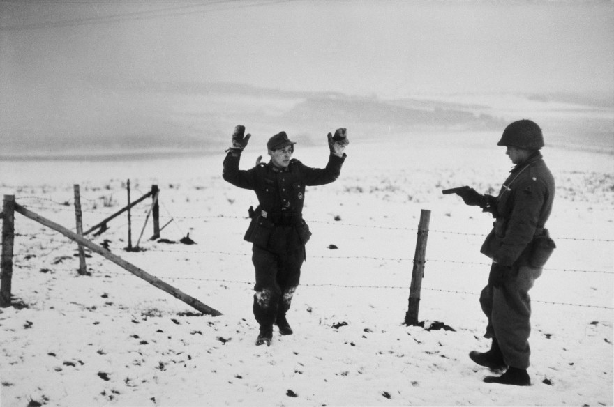 BELGIUM. Near Bastogne. December 23rd-26th, 1944. A US soldier with a German prisoner of war during the Battle of the Bulge.