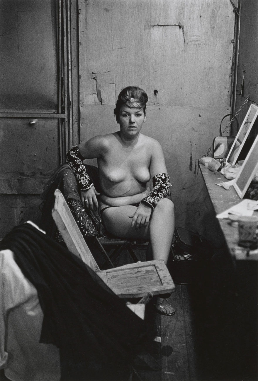 MONROWE - Stripper with bare breasts sitting in her dressing room, Atlantic City, N.J. 1961 © The Estate of Diane Arbus, LLC. All Rights Reserved