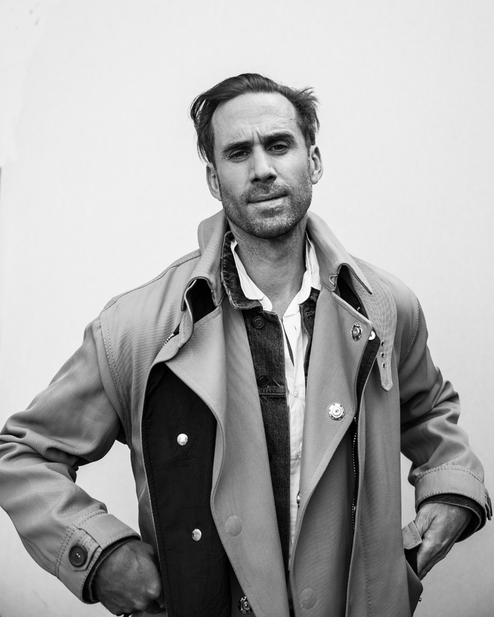 Photo of Actor Joseph Fiennes, from Handmaid's Tale photographed in studio in black and white. Wearing Giorgio Armani, Saint Laurent, and Maison Margiela