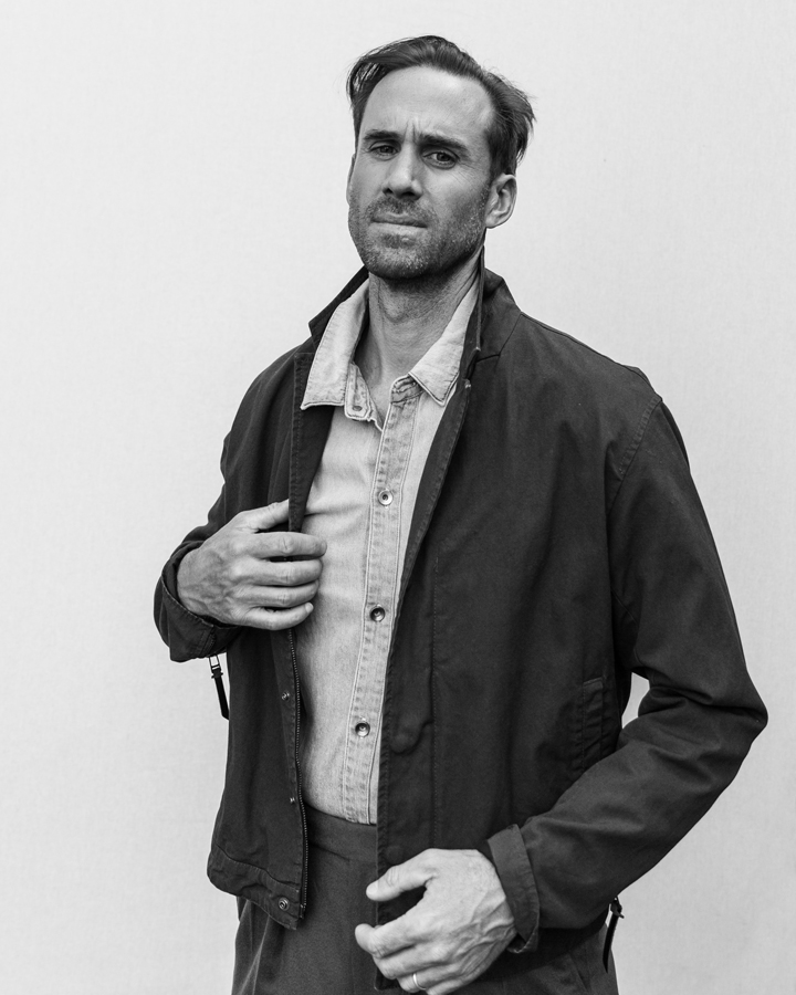 Photo of Actor Joseph Fiennes, from Handmaid's Tale photographed in studio in black and white wearing Robert Geller