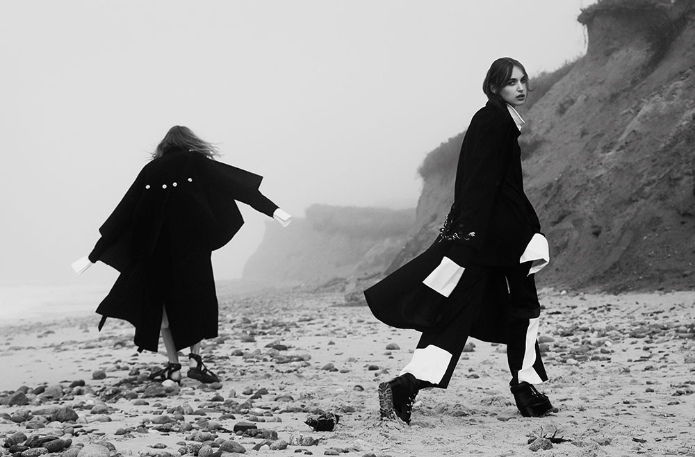 Models Yulia and Stasha photographed in black and white by photographer Vera Comploj for MONROWE Magazine. Yulia in oversized Button-Up Shirt and Wool Coat by Daniel Gregory Natale and Stasha in Navy French Cuff Dress and Black Trousers with White Side Stripe and Wool Coat by Devon Halfnight Leflufy Platform LaceUp Shoes by Sacai.